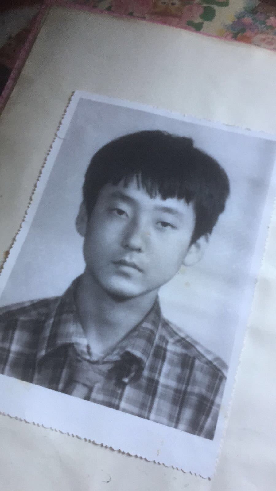 Ma Ju, 16, poses for his first passport photo in China, 1990.
