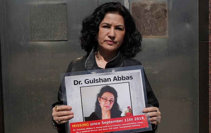 Rushan Abbas, executive director of the Campaign for Uyghurs, holds a photo of her sister, who is imprisoned in a Chinese camp, during a rally in New York on March 22, 2021.