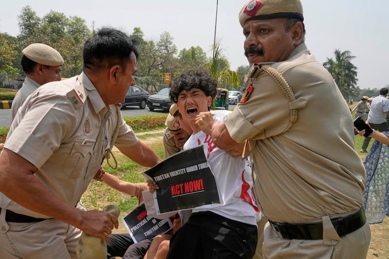 Policemen detain exiled Tibetans protesting against the death of Tulku Hungkar Dorje, a revered Tibetan religious leader, while in custody in Vietnam, outside Chinese embassy in New Delhi, India, April 11, 2025.