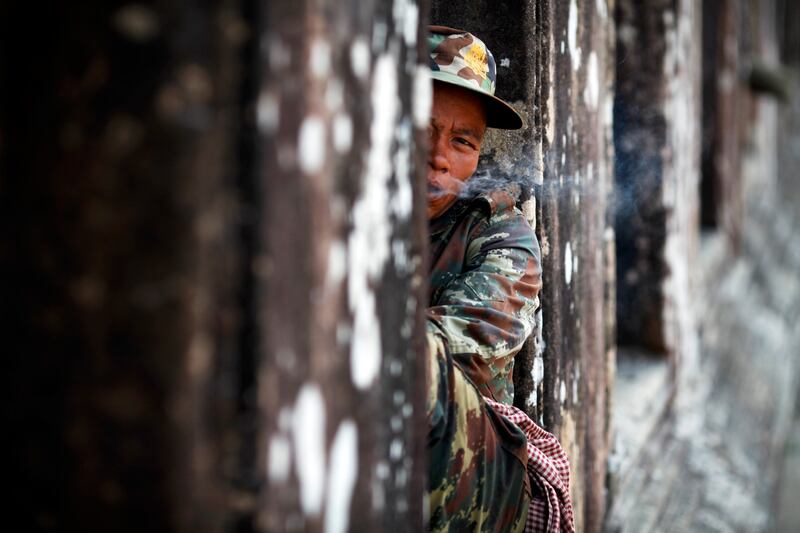 In this Feb. 9, 2011, photo, a Cambodian soldier smokes a cigarette at the 11th-century Preah Vihear temple on the border between Thailand and Cambodia.