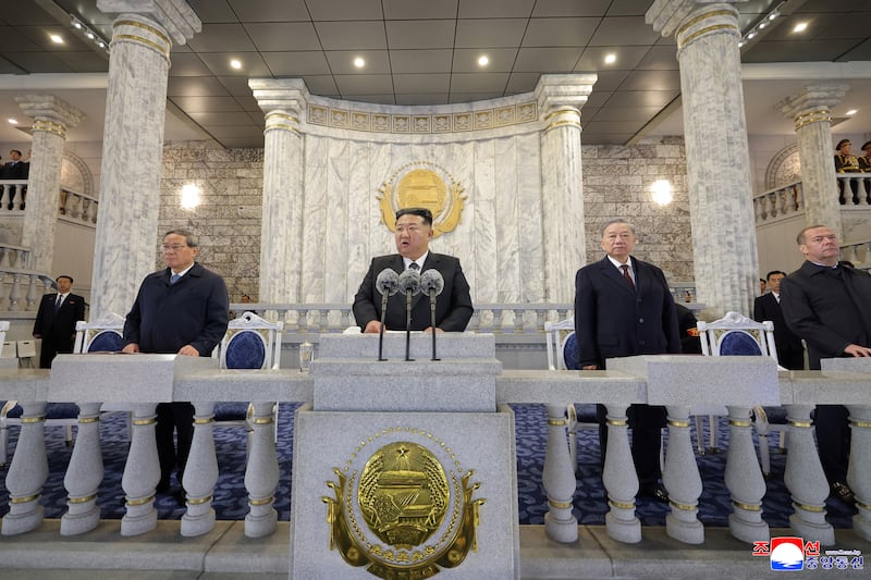 North Korean leader Kim Jong Un speaks alongside General Secretary of the Communist Party of Vietnam To Lam, Deputy Chairman of the Russian Security Council and leader of the United Russia political party Dmitry Medvedev and China’s Premier Li Qiang as they attend a military parade celebrating the 80th anniversary of the founding of the ruling Workers' Party of Korea at Kim Il Sung Square in Pyongyang in this image released October 11, 2025 by the North Korean government.