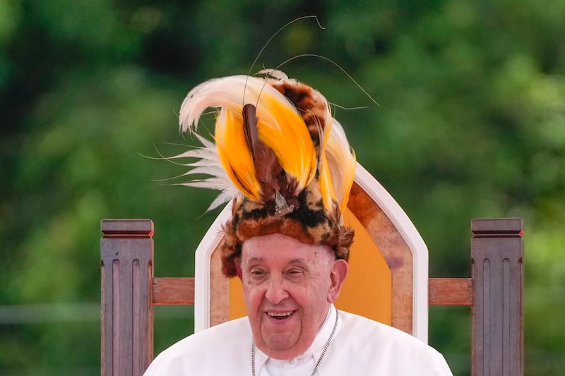 Pope Francis wears a traditional hat during a meeting with faithful in Vanimo, Papua New Guinea, Sept. 8, 2024.
