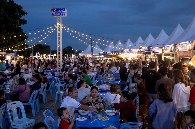 People eat at a night market in Vientiane, Oct. 28, 2023. (Jack Taylor/AFP)