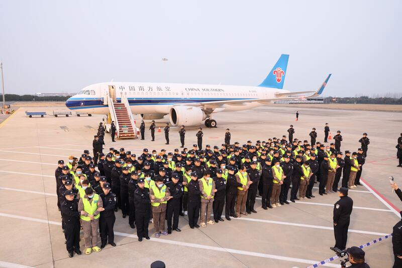 In this Feb. 20, 2025, image released by the Chinese government, a group of 200 Chinese citizens suspected of involvement in scam centers are returned to China under the escort of Chinese police after being repatriated from Myawaddy in Myanmar.